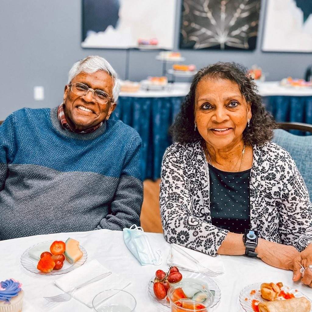 two people enjoying some fruit