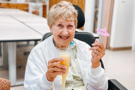a woman smiling with a drink