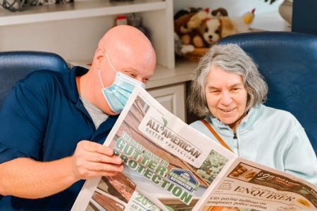 a man reads a woman the newspaper